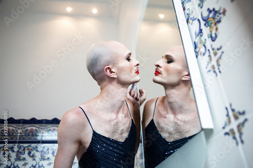 Person doing makeup in front of a mirror