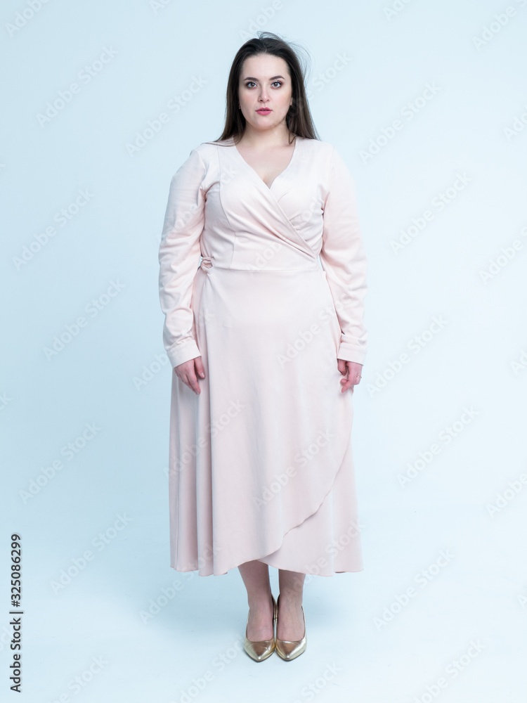 Plus Size Model with long hair posing in studio Plus Size Model with long hair posing in studio