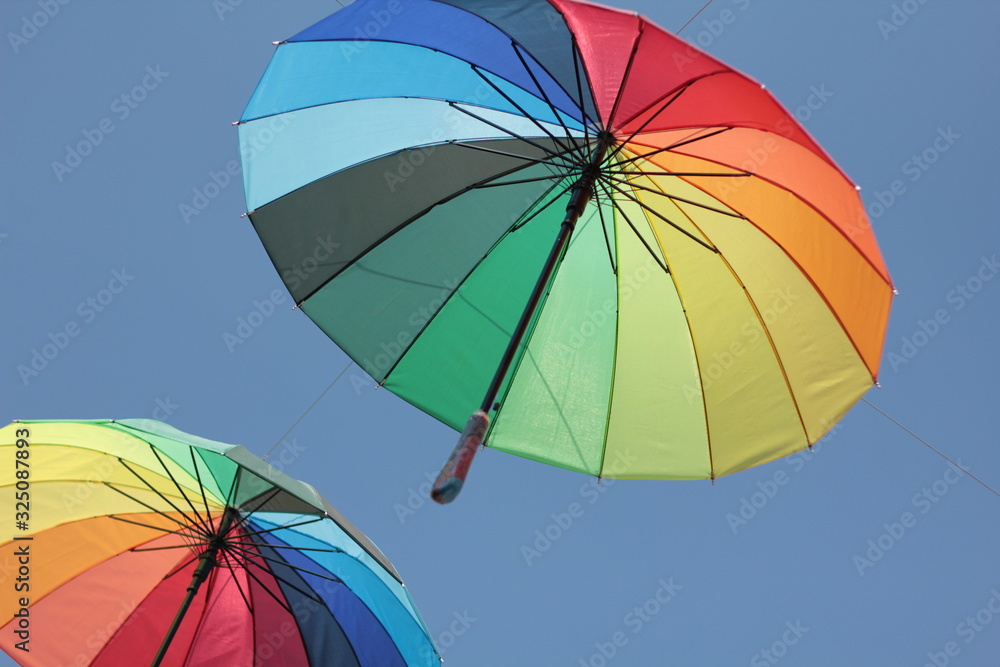 colorful umbrella hang on the air with blue sky background colorful umbrella hang on the air with blue sky background