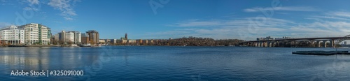 Sunny winter view over the bay between the Stockholm districts Marievikshamn, Årstadal, Tantolunden, Hornstull, Liljeholmen and the Årsta train bridges