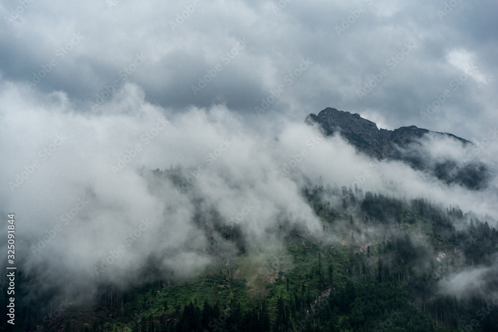 Misty Clouds moving in front of a bavarian mountain peak Misty Clouds moving in front of a bavarian mountain peak