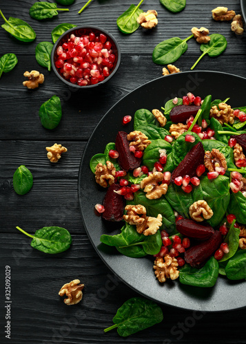 Healthy Beet Salad with fresh sweet baby spinach, pomegranate seeds and candy walnut. healthy Vegan vegetarian, plant based food