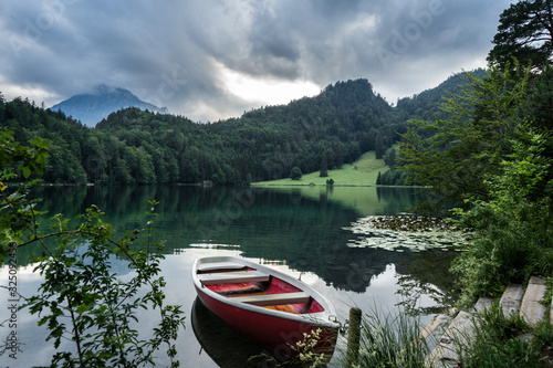 Cute boat on a calm bavarian lake in the mountains
