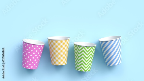 Принти на полотні Four paper cups with different colorful patterns on blue pastel background