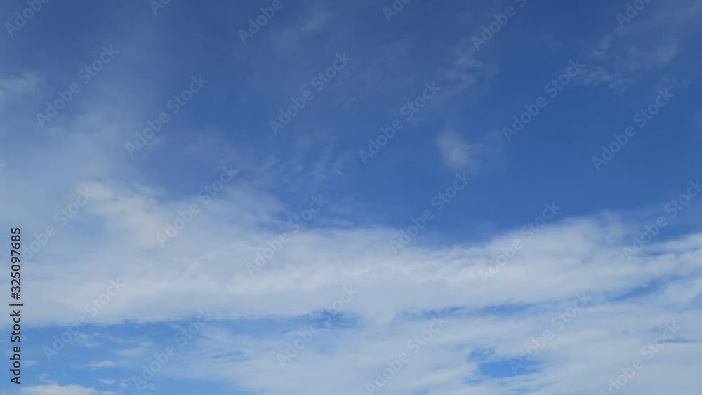 Sunny blue sky background with natural white Cirrostratus or Cirrocumulus clouds formation slowly building, moving & flying TimeLapse. Puffy & fluffy cloud in tropical summer clear sky on sunshine day Sunny blue sky background with natural white Cirrostratus or Cirrocumulus clouds formation slowly building, moving & flying TimeLapse. Puffy & fluffy cloud in tropical summer clear sky on sunshine day