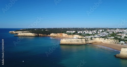 Wallpaper Mural Aerial drone video of the beautiful Praia da Senhora da Rocha (Senhora da Rocha Beach) with the white chapel on the rocks, near Armacao de Pera, Algarve, Portugal Torontodigital.ca