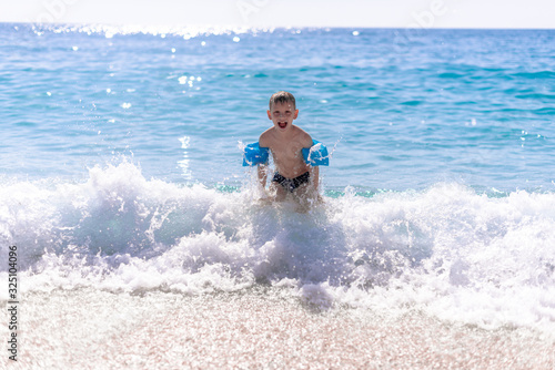 One boy is playing on the beach