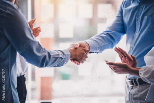 Business success. Businessman shaking hands agreement confirmed in the investment business.