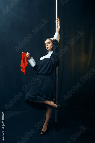 Perverse nun dances on a pole with panties in hand