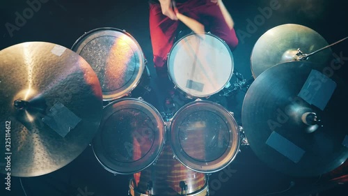 View from above on the drums and cymbals during playing. Drum set, drum kit in dark, drummer plays a concert. photo
