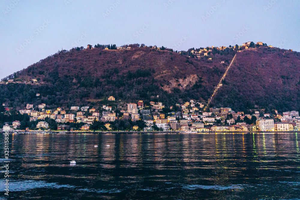Lake Como, in the Italian Alps, during sunset, near the town of Como, Italy - February 2020.