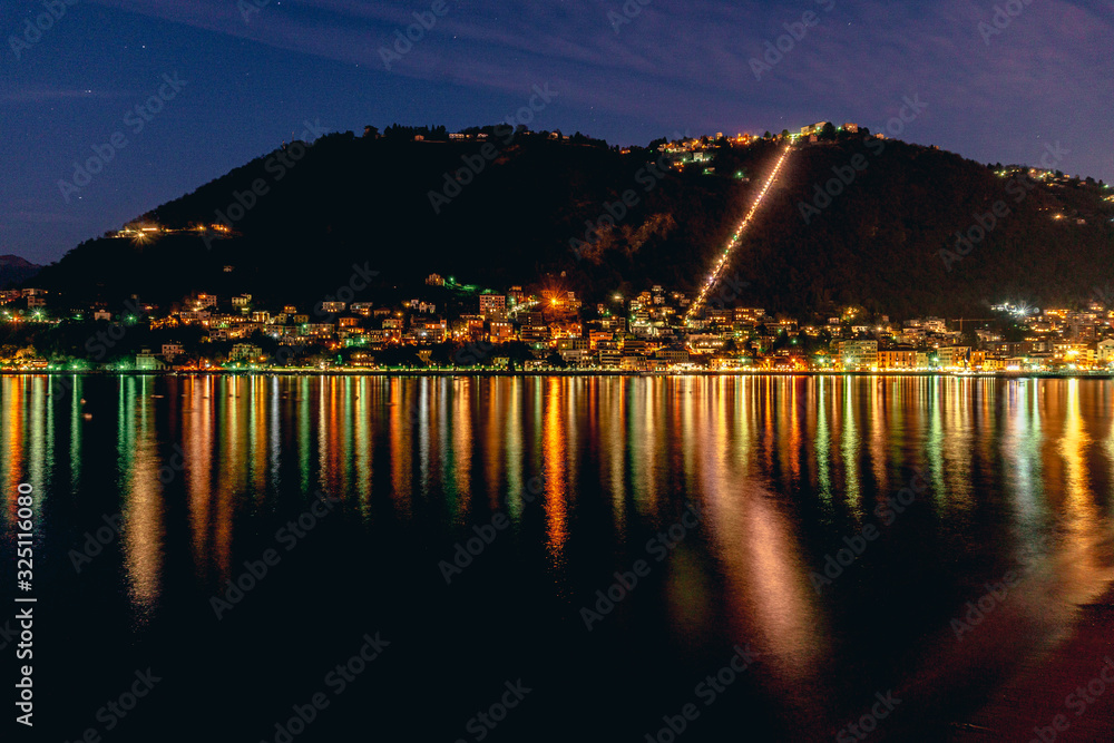 Lake Como, in the Italian Alps, during a starry night, near the town of Como, Italy - February 2020.