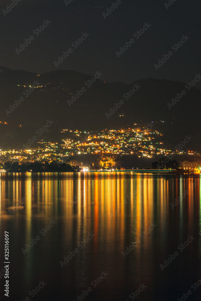 Lake Como, in the Italian Alps, during a starry night, near the town of Como, Italy - February 2020.