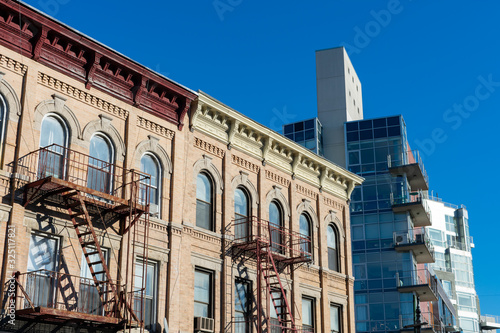 Old Buildings with Fire Escapes next to a Modern Residential Building in Greenpoint Brooklyn New York © James