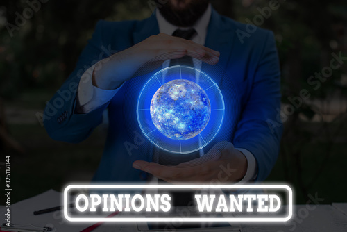 Conceptual hand writing showing Opinions Wanted. Concept meaning judgment or advice by an expert wanted a second opinion Elements of this image furnished by NASA photo