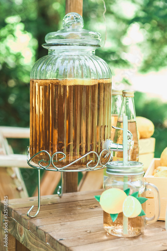 a glass of lemonade on the table in the garden