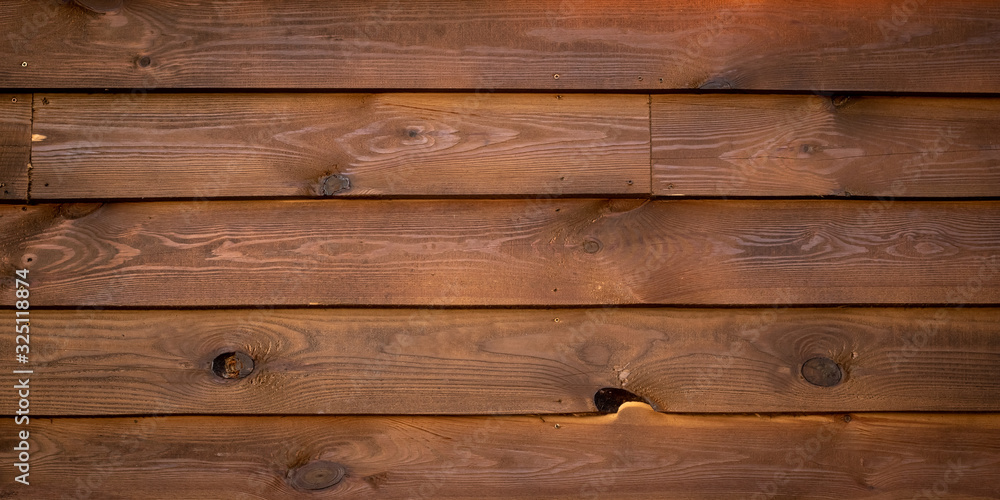 Old wood planks background with a knots. Wooden texture with snags. Timber fence, desk surface. Natural dark color. Weathered brown table. Old wood planks background with a knots. Wooden texture with snags. Timber fence, desk surface. Natural dark color. Weathered brown table.