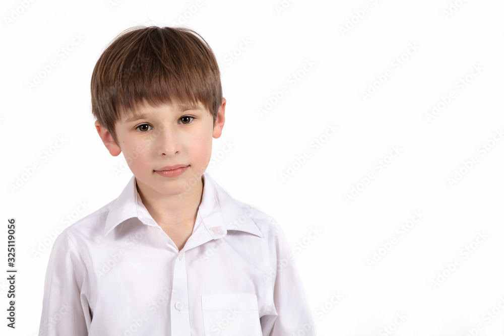 Portrait of a seven year old boy on a white background. Primary school student. Beautiful child in a white shirt . Portrait of a seven year old boy on a white background. Primary school student. Beautiful child in a white shirt .