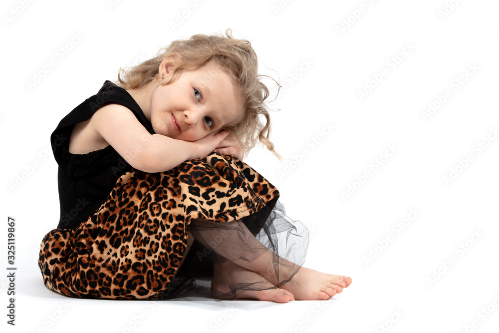 Pretty Baby. Little blonde girl on a white background. A four-year-old child sits hugging his knees. Pretty Baby. Little blonde girl on a white background. A four-year-old child sits hugging his knees.