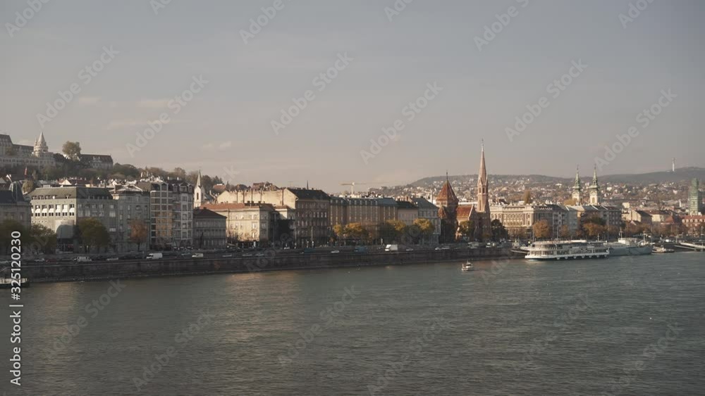 Gimbal pan shot left to right of Buda and river Danube in winter under blue grey sky. Pan shot of left side, Buda, in Budapest during orange grey sunset Gimbal pan shot left to right of Buda and river Danube in winter under blue grey sky. Pan shot of left side, Buda, in Budapest during orange grey sunset