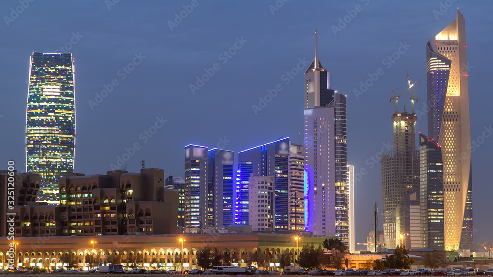 Skyline with Skyscrapers day to night timelapse in Kuwait City downtown illuminated at dusk. Kuwait City, Middle East Skyline with Skyscrapers day to night timelapse in Kuwait City downtown illuminated at dusk. Kuwait City, Middle East
