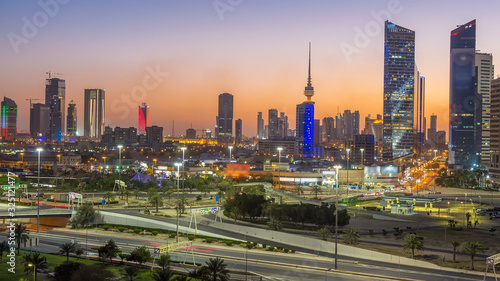 Skyline with Skyscrapers day to night timelapse in Kuwait City downtown illuminated at dusk. Kuwait City, Middle East
