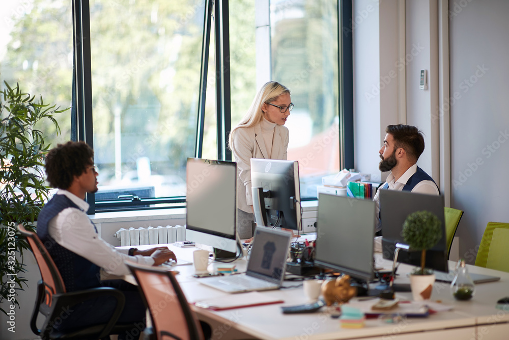 blonde female boss talking to employees at the modern bright office. communication, conversation, work, business, concept blonde female boss talking to employees at the modern bright office. communication, conversation, work, business, concept