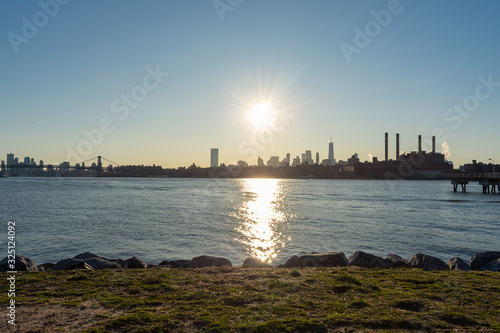 Shore of Transmitter Park in Greenpoint Brooklyn New York along the East River with a view of the Manhattan Skyline before Sunset