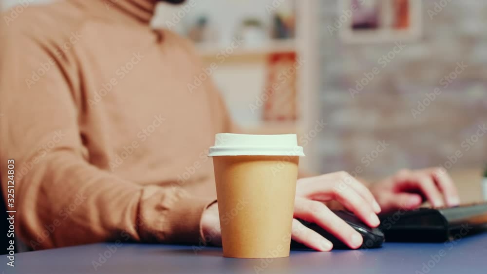 Close up of male engineer picking up his coffee Close up of male engineer picking up his coffee