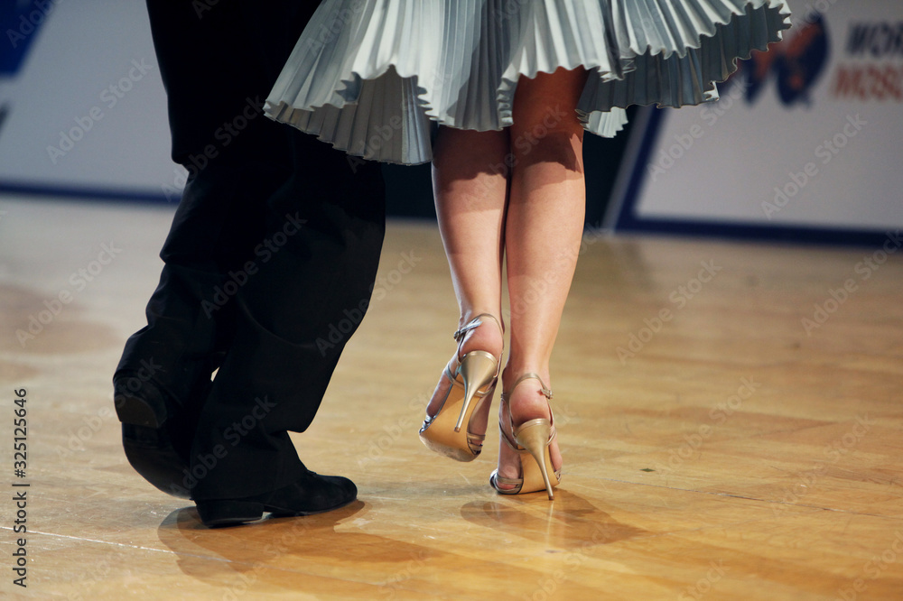 Graceful lines of legs of Argentina tango dancers