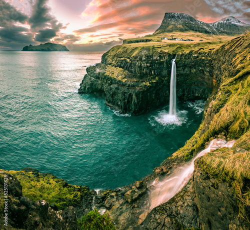 Fototapeta Naklejka Na Ścianę i Meble -  Sunset over the village of Gasadalur and waterfall at Vagar Island, Faroe Islands 