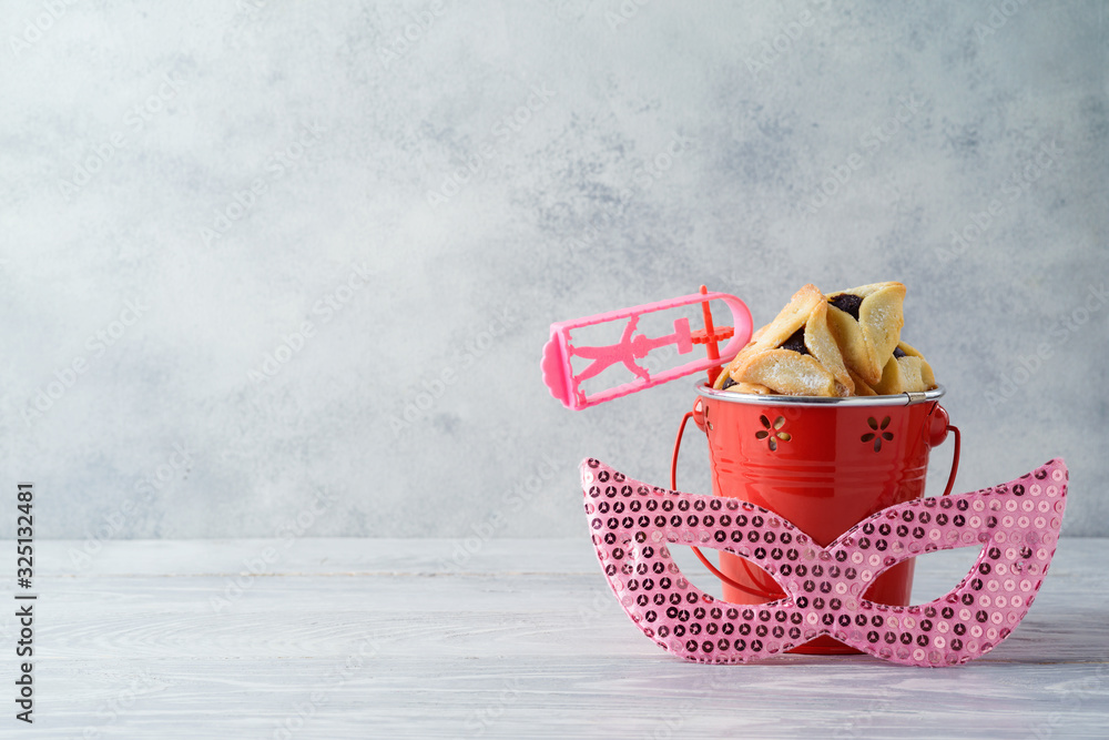Jewish holiday Purim celebration background with hamantaschen cookies on wooden table Jewish holiday Purim celebration background with hamantaschen cookies on wooden table