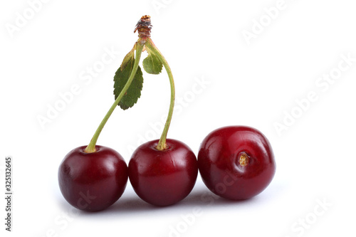 Cherries and leaves isolated on white background