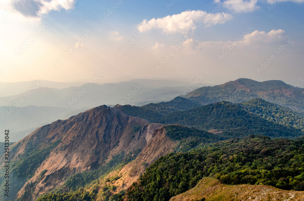 A panoramic view of the forest on the mountain at sunset, the sunlight shines on the mountains have beautiful shadows light at Mulayit Taung, Myanmar.