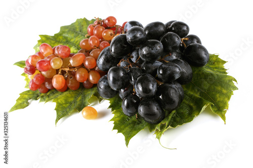 Grape on autumn leaves. Different color grape