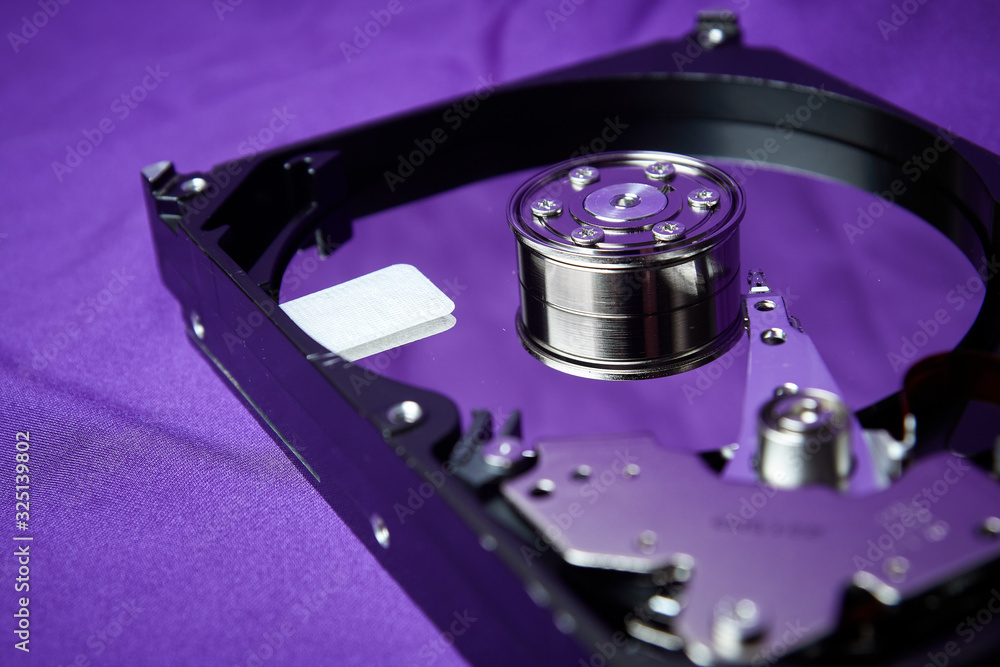 Opened hard drive from the computer hdd disk drive with mirror effects. Disassembled hard drive from the computer Opened hard drive from the computer hdd disk drive with mirror effects. Disassembled hard drive from the computer