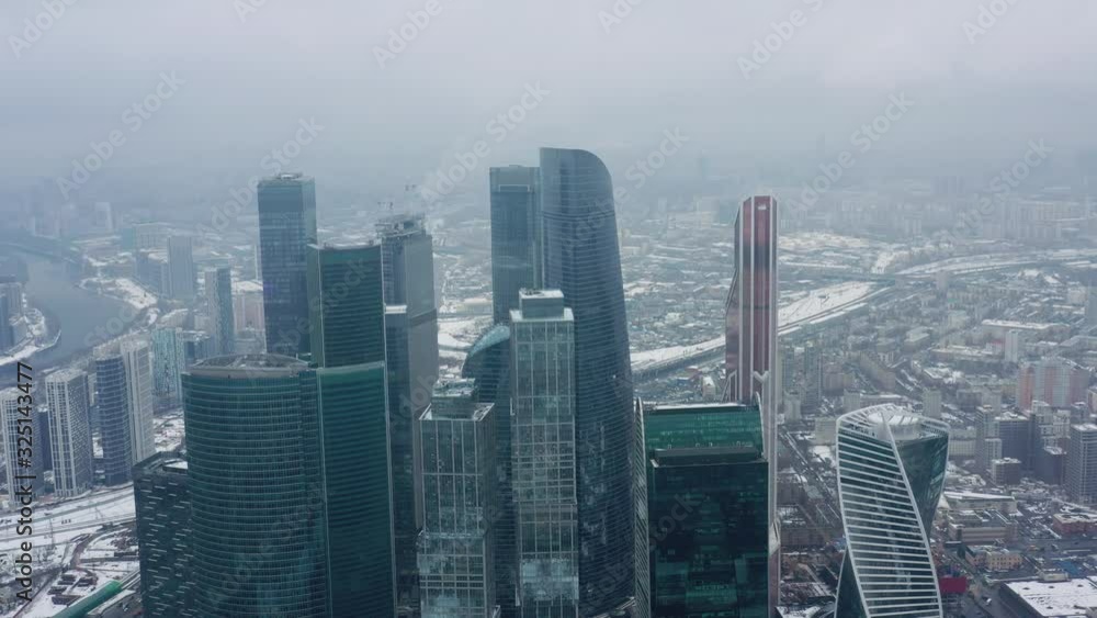 Aerial drone shot flying over center of Moscow city buildings, skyscrapers at cloudy winter day. Drone shot flying over Moscow skyscrapers. Aerial drone shot flying over center of Moscow city buildings, skyscrapers at cloudy winter day. Drone shot flying over Moscow skyscrapers.