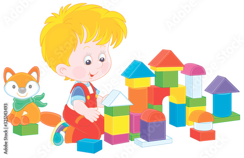 Little boy smiling, playing with color bricks and constructing a toy fortress for a game, vector cartoon illustration on a white background