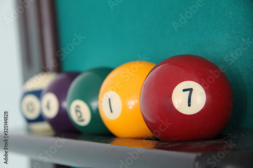billiard balls on a stand red ball under the number seven