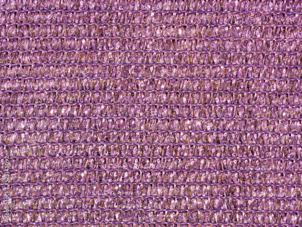 Grainy lilac shiny woven grid texture use as background. Fabric sparkle, texture. Gradient on textile, clothes. Glitter wall. Material pattern, metallic tinsel, decoration