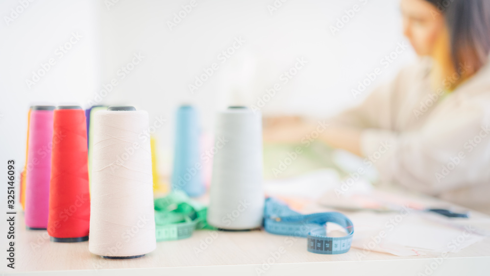 Colorful thread with blur Women fashion designer background in home. Start up. Business ideas concepts. Colorful thread with blur Women fashion designer background in home. Start up. Business ideas concepts.
