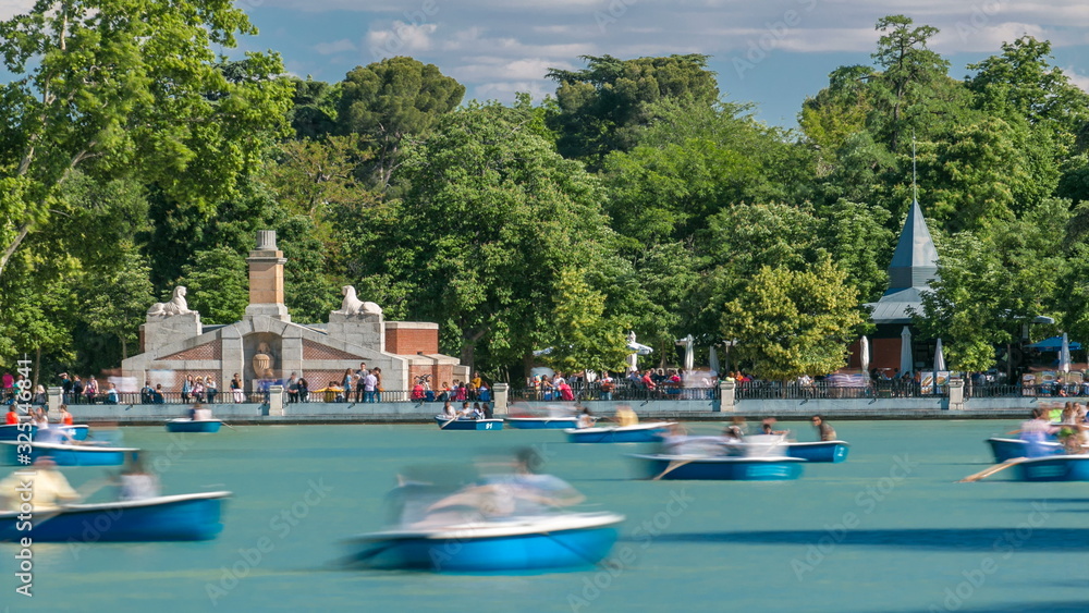 Tourists on boats at lake near Monument to Alfonso XII timelapse in the Parque del Buen Retiro - Park of the Pleasant Retreat in Madrid, Spain