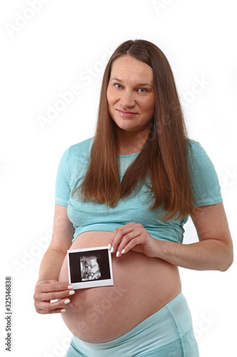 Pregnant woman holds ultrasonography baby picture