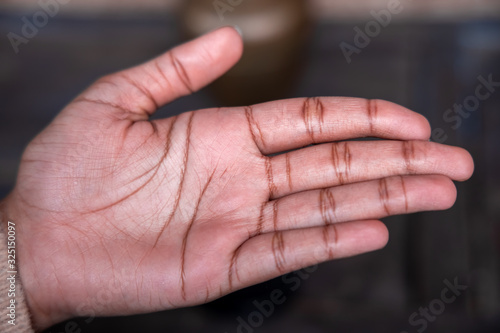 Close-up Textured Visible palm lines on the hand of an Asian Girl photo