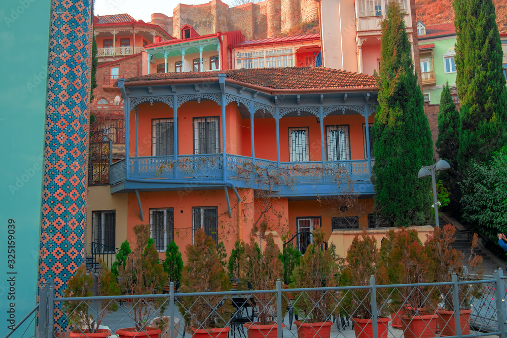 Fototapeta premium residential buildings with traditional carved wooden balconies on the rock of Tbilisi, Georgia