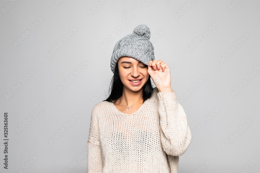 Beautiful woman wearing warm clothes, winter portrait isolated on grey background. Beautiful woman wearing warm clothes, winter portrait isolated on grey background.
