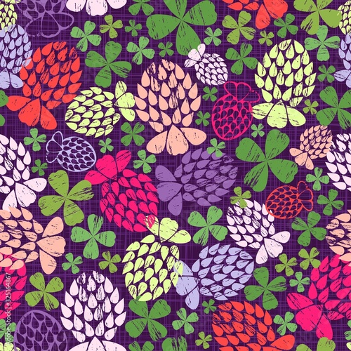 Stylized clover flowers and leaves in various bright neon colours scattered on a dark purple textured background. The non-directional print. Vintage-inspired whimsical abstraction based on geometry.