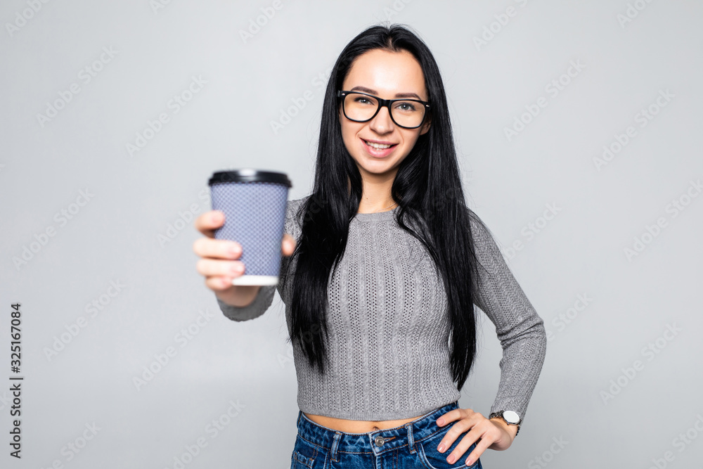 Portrait of a pretty woman holding takeaway coffee cup isolated over gray background Portrait of a pretty woman holding takeaway coffee cup isolated over gray background
