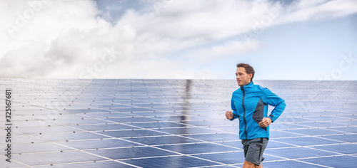 Solar panels farm runner active man athlete jogging by outdoor background header panoramic.