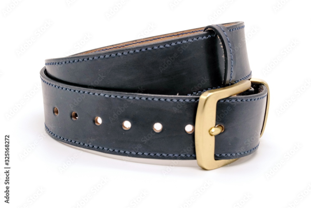 sample of classic leather men's belt with metal shiny buckle handmade in black twisted into a ball, the concept of manual craft,close up sample of classic leather men's belt with metal shiny buckle handmade in black twisted into a ball, the concept of manual craft,close up